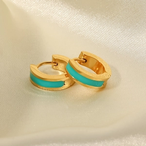 Detail of 18K gold plated titanium earrings with turquoise enamel inlay on satin
