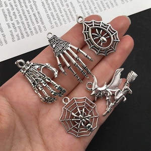 Silver Halloween charms including skeleton hand, spider web, and witch for DIY jewelry