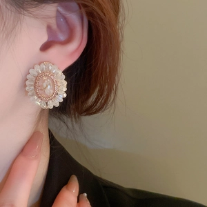 Floral oval stud earrings featuring synthetic crystals and vintage gold bead trimming