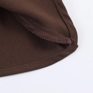 Detailed view of dark brown twill fabric with professional double-stitched hem finish