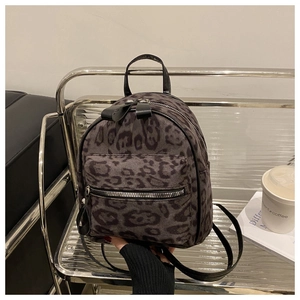 Detailed view of trendy leopard print mini backpack showing plush texture and metal zipper