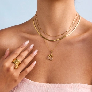 Elegant 18K gold plated titanium steel cherry pendant necklace and wide ring on model