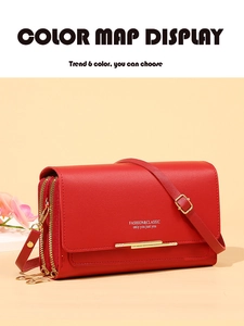 Detailed view of red textured leather bag with gold hardware and fashion classic slogan
