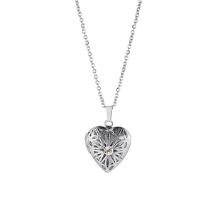 Detail of silver heart locket pendant with intricate filigree and round zircon stone