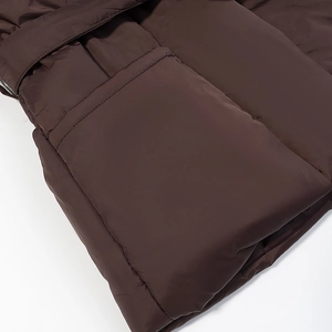 Close-up of quilted seams and matte texture on a brown padded winter jacket side pocket