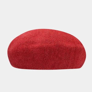 Detailed view of red beret hat with subtle glitter yarn and warm knit texture