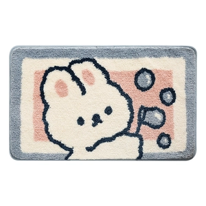Soft absorbent bathroom rug featuring a cute cartoon rabbit blowing bubbles on blue background