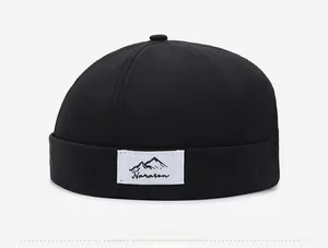 Detail view of the black Miki Hat featuring a Narason logo patch and six-panel stitching