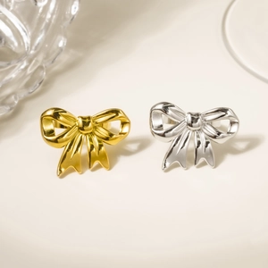 Elegant 18K gold and silver bow-shaped stainless steel rings with a polished finish