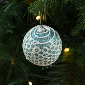 Detail of light blue Christmas ball with silver glitter and 3D mesh texture on tree