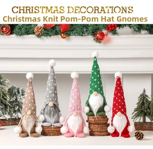 Close-up of five knitted Christmas gnomes with long white beards on a wooden base