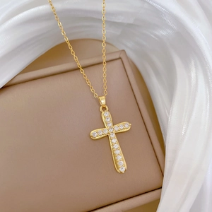 Detailed close-up of a luxury gold-plated cross necklace with shimmering crystal stones