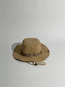 Detail of khaki outdoor sun hat featuring metal ventilation eyelets and windproof strap