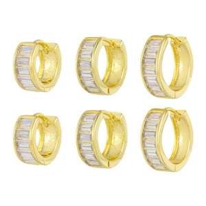 Three pairs of gold huggie earrings with baguette cut cubic zirconia in channel setting