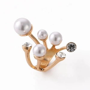 Golden irregular open ring featuring elegant pearls and zircon stones on a white background