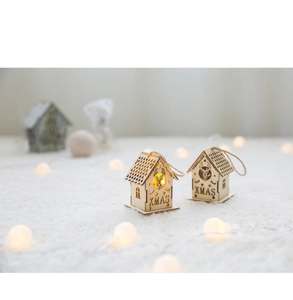 Close-up of lighted wooden Christmas house ornaments with XMAS engraving and deer pattern