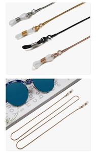 Detailed macro view showing four metallic colors of snake chain eyewear retainers with clips