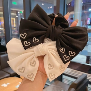 Elegant black and white satin bow scrunchies with sparkling rhinestone heart patterns