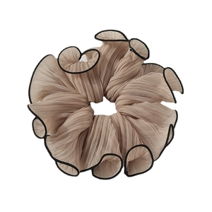 Elegant champagne organza pleated scrunchie with black trim for stylish ponytails