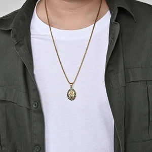 Golden Saint Michael oval pendant necklace on male model with Saint Michael Protect Us text