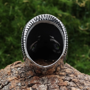 Vintage stainless steel skull biker ring for men with textured details on wood