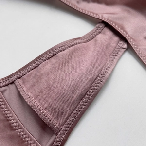 Close-up of seamless ice silk thong featuring breathable cotton lining in dusty rose
