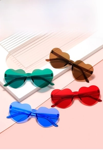 Collection of four colorful heart-shaped rimless sunglasses in green, amber, red and blue
