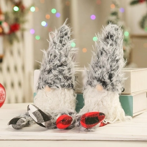 Macro view of Christmas gnomes with plaid hats and long plush beards on books
