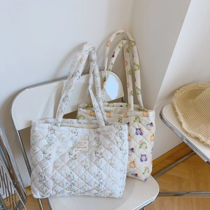 Detailed texture of quilted cotton tote bags with floral and cartoon character patterns