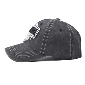 Detail of washed cotton baseball cap featuring white contrast stitching and embroidery