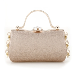 Detail of champagne gold evening bag with sequins and pearl rhinestone handle decoration