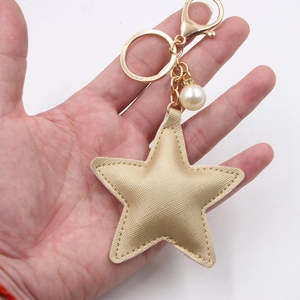 Handheld gold PU leather star keychain with fine cross texture and pearl lobster clasp