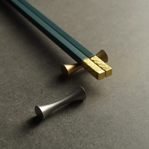 Retro stainless steel dark green chopsticks with gold metal tips and dumbbell-shaped rests