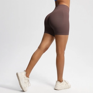 Detail showing high-waisted seamless dark brown fitness shorts with butt-lifting effect