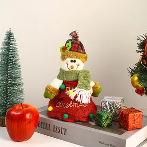 Detail of plush snowman Christmas candy bag with red plaid hat and Merry Christmas embroidery