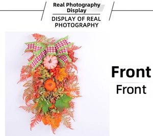 Detailed view of autumn door swag with pumpkins, berries, maple leaves, and a plaid bow
