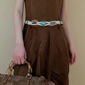 Detail of woven cotton waist belt featuring turquoise stone and dark wooden beads
