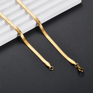 Detail of gold-plated flat snake chain showing the lobster clasp and fine texture