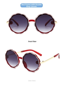 Macro view of round flower-shaped red frame kids sunglasses with gold metal temples