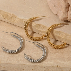 Gold and silver twisted C-shaped hoop earrings with spiral metal wire wrap design