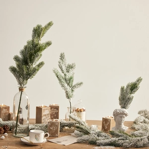 Realistic flocked artificial Christmas pine branches with snow effect for festive decor