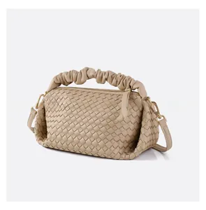 Detailed view of beige woven leather handbag showing ruffled handle and fine texture