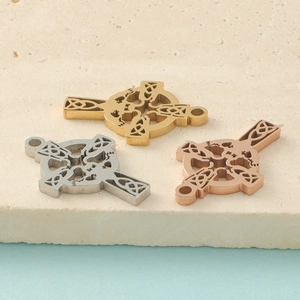 Detailed macro view of Celtic knot cross pendants in gold, silver, and rose gold finish