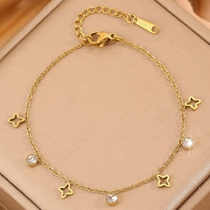 Elegant gold titanium steel bracelet featuring hollow star charms and clear zircon stones