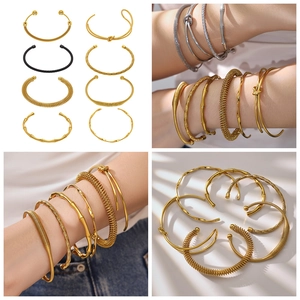 Detailed set of gold, silver and black bamboo style knot cuffs in 18k plated steel
