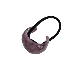 Minimalist purple marble resin hair tie with a black elastic band on white background