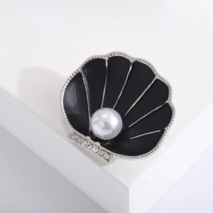 Elegant black enamel shell brooch with a lustrous white pearl and rhinestone accents