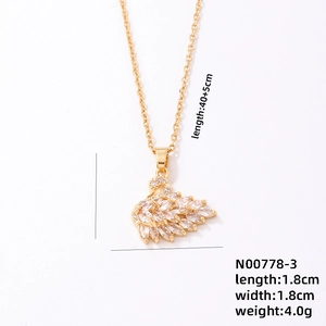 Macro detail of golden swan necklace showing marquise crystal inlay and size specifications
