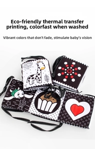 Detailed view of black and white baby cloth book with giraffe and turtle patterns