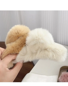 Detail of plush faux fur hair claws in beige and brown colors for soft winter styling